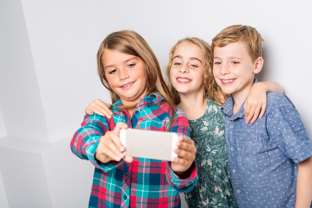 A Group of happy children in studio gray background